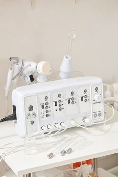 Cosmetic Multifunctional Device close-up in beauty salon. Ultrasound medical device. Darsonval device. Ultrasound procedure. Medical equipment healthcare. Young skin. Face professional massage.