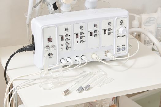 Cosmetic Multifunctional Device close-up in beauty salon. Ultrasound medical device. Darsonval device. Ultrasound procedure. Medical equipment healthcare. Young skin. Face professional massage.