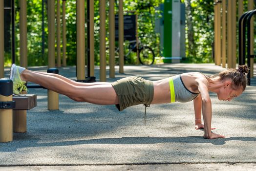 sporty young girl wrung out, workout outdoors