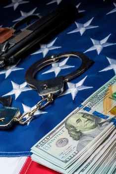 concept photo crime and punishment withdrawn money and weapons on the American flag