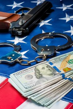 crime and punishment seized money and weapons on the American flag concept photo