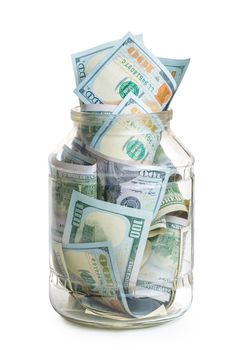 concept photo savings - a glass jar filled with 100 dollar bills isolated