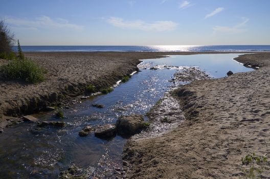 Small stream on arrival at the coast of Valencia, Spain in the town of Alboraya