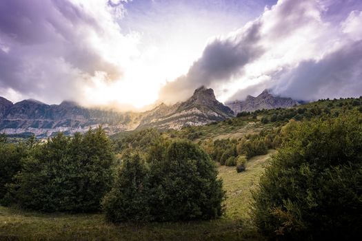 Clouds passing over the mountains, the sun shines at dawn