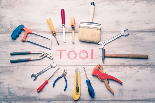 Set of work tool on rustic wooden background with written "tool" in space, industry engineer tool concept.still-life.close up.