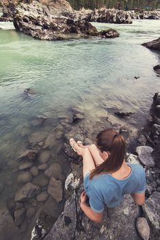 Woman resting at river in Altai Mountains territory