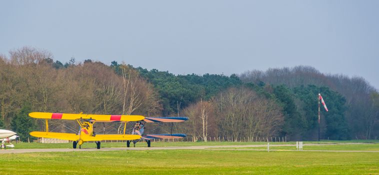 two stunting airplanes taking off on the airport, acrobatic flying and extreme sports