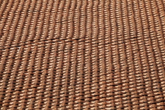 Roof of a house covered with old red tiling