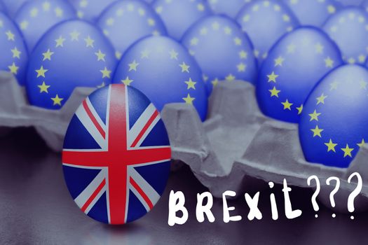 Concept of Brexit is presented from jumping egg with a British flag out of the box with eggs with the flag of the European Union and Brexit inscribed with question marks.