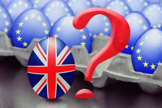 Concept of Brexit is presented from jumping egg with a British flag out of the box with eggs with the flag of the European Union and question mark.