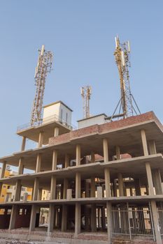 Three communication antennas on a building under construction in the city of hurghada