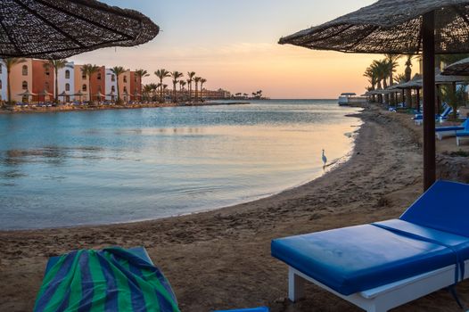View of a lagoon of the Red Sea at sunrise between two rows of hotel room in Hurghada