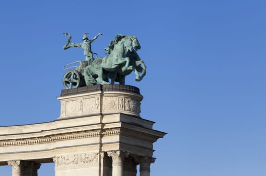 Statue of a man on a chariot, symbol of war, on a colonnade in Heroes Square, Budapest, Hungary