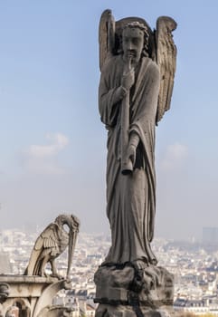 Archangel Gabriel blowing in his horn on the roof of Notre-Dame de Paris, France