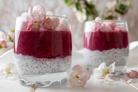 Layered chia pudding with yogurt, blueberries and apple blossoms