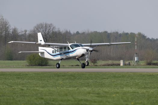 Single-engined propeller business plane during take off at a small airport
