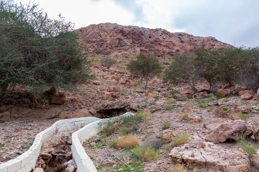 Irrigation canal called falaj in Muscat neighborhood, Oman.