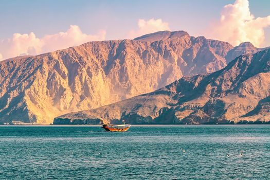 Sea, pleasure boats, rocky shores in the fjords of the Gulf of Oman.