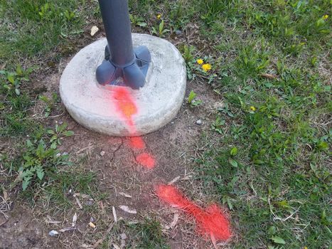 red paint on grass or ground and street light or post