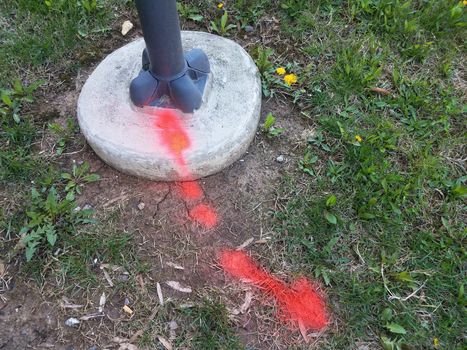 red paint on grass or ground and street light or post