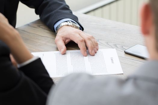 Business people discussing contract close up view of papers