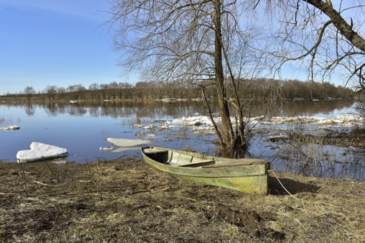 spring spill, boat on the river bank