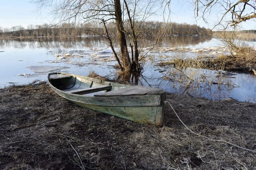 spring spill, boat on the river bank