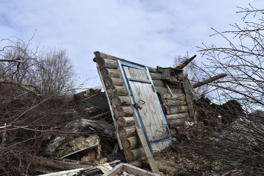 destroyed village house, remained part of the wall with a door