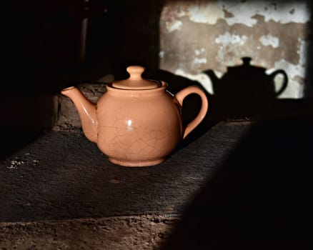 old cracked kettle on the stove, image of village life