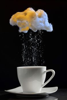Cup of coffee with cotton wool cloud and rainy sugar