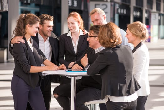Group of happy business people congratulating their successful coworker
