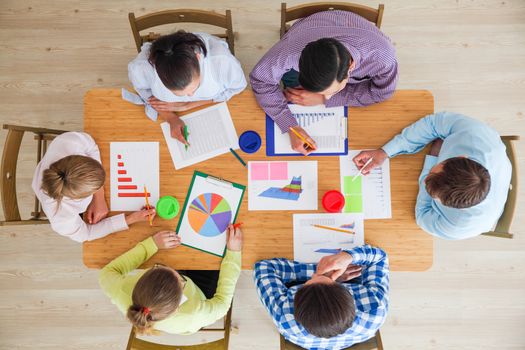 Business team meeting, people in casual clothes working with financial statistics at office desk