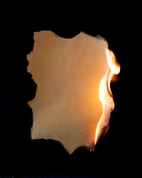 burning piece of  paper on black background