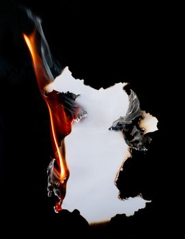 burning piece of  paper on black background