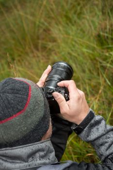 A photographer with a camera in the rain