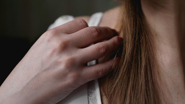 Hands of woman undressing white bra. Hands of woman undressing brassiere. Close-up nude photo