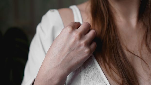 Hands of woman undressing white bra. Hands of woman undressing brassiere. Close-up nude photo