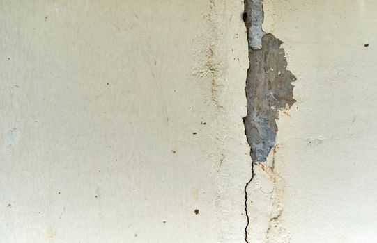 Crack concrete wall or abandoned grunge cracked stucco wall use as texture and background.