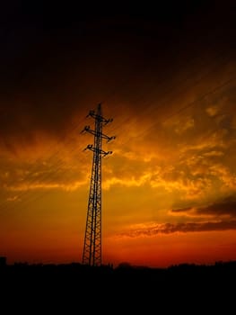 Electric pole and electric cable on the field in the countryside.