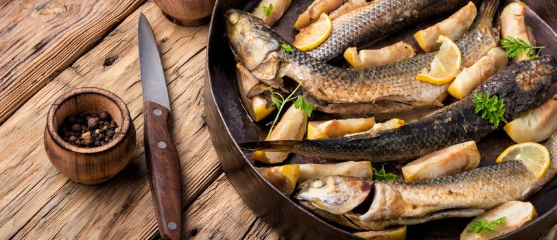 Baked fish in apples, lemon and spices.Delicious fish