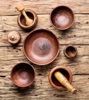 Empty wooden mortar and pestle on wooden old background.Cooking utensils