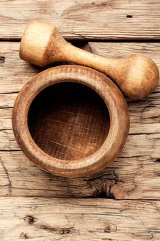 Empty wooden mortar and pestle on wooden old background