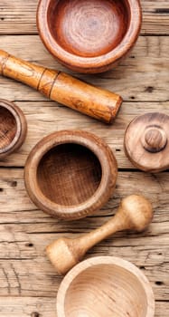 Empty wooden mortar and pestle on wooden old background