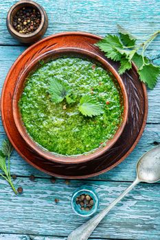 Stinging nettles soup on rustic kitchen table