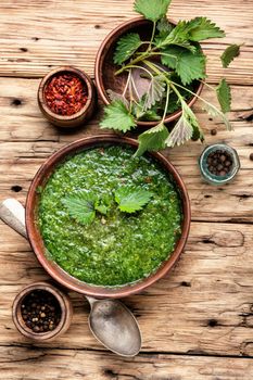 Stinging nettles soup on rustic kitchen table