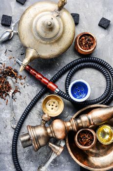 East smoking hookah. Arabian shisha with tea. Hookah and tea.Shisha concept.