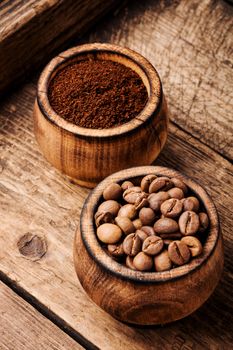 Roasted coffee beans and ground coffee.Coffee beans on wood background