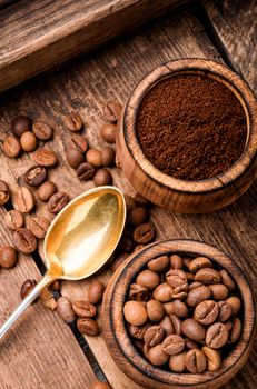 Roasted coffee beans and ground coffee.Coffee beans on wood background