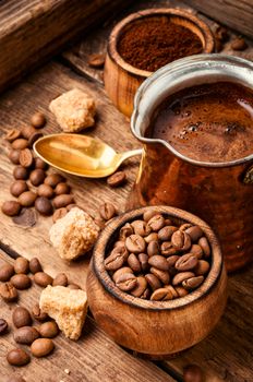 Roasted coffee beans and ground coffee.Coffee beans on wood background