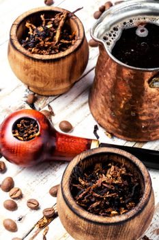 Stylish tobacco pipe with tobacco and brewed coffee